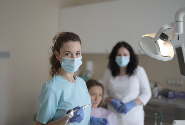 dental associates with patient in exam room